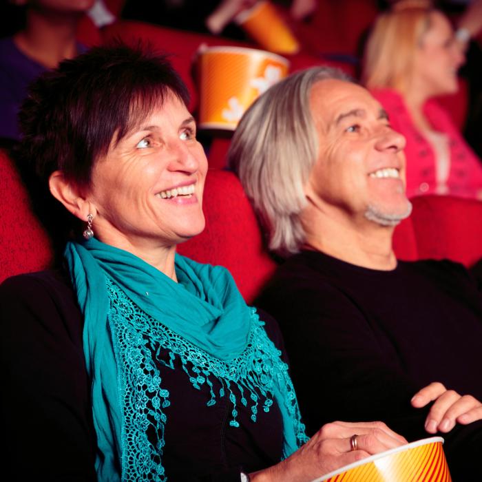 Couple Sat in a Cinema Screening Looking at the Screen