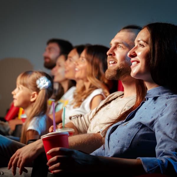 Young Family Enjoying a Film in a Cinema Screen